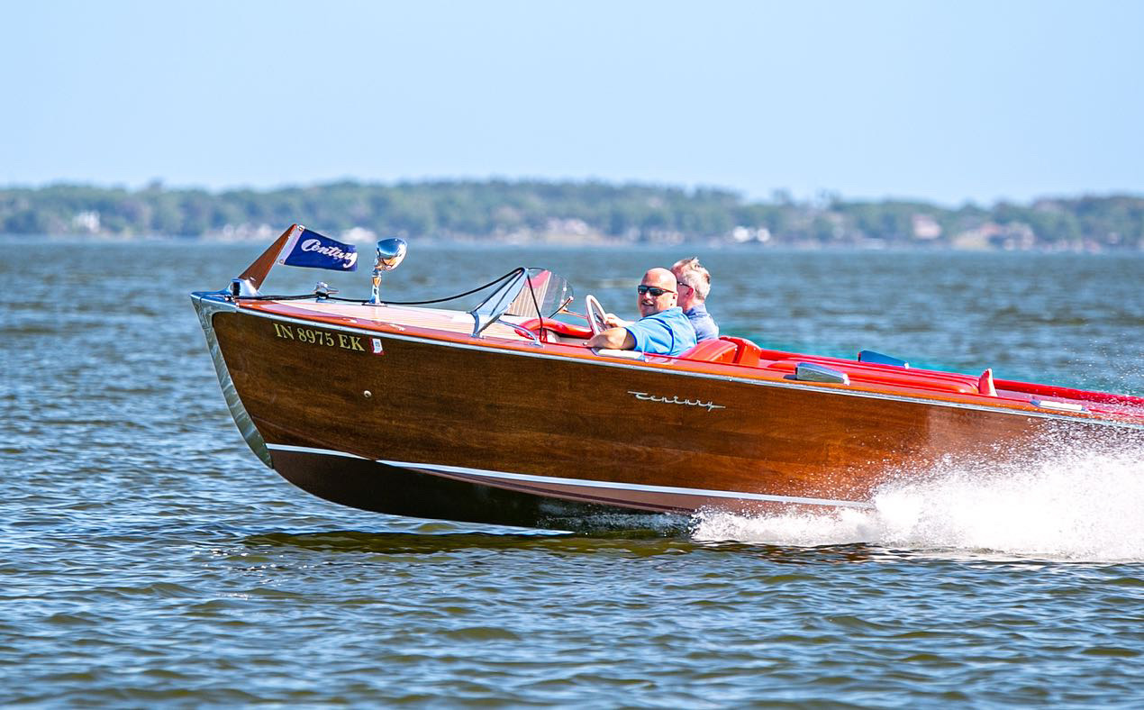 Classic wooden boat running on the water