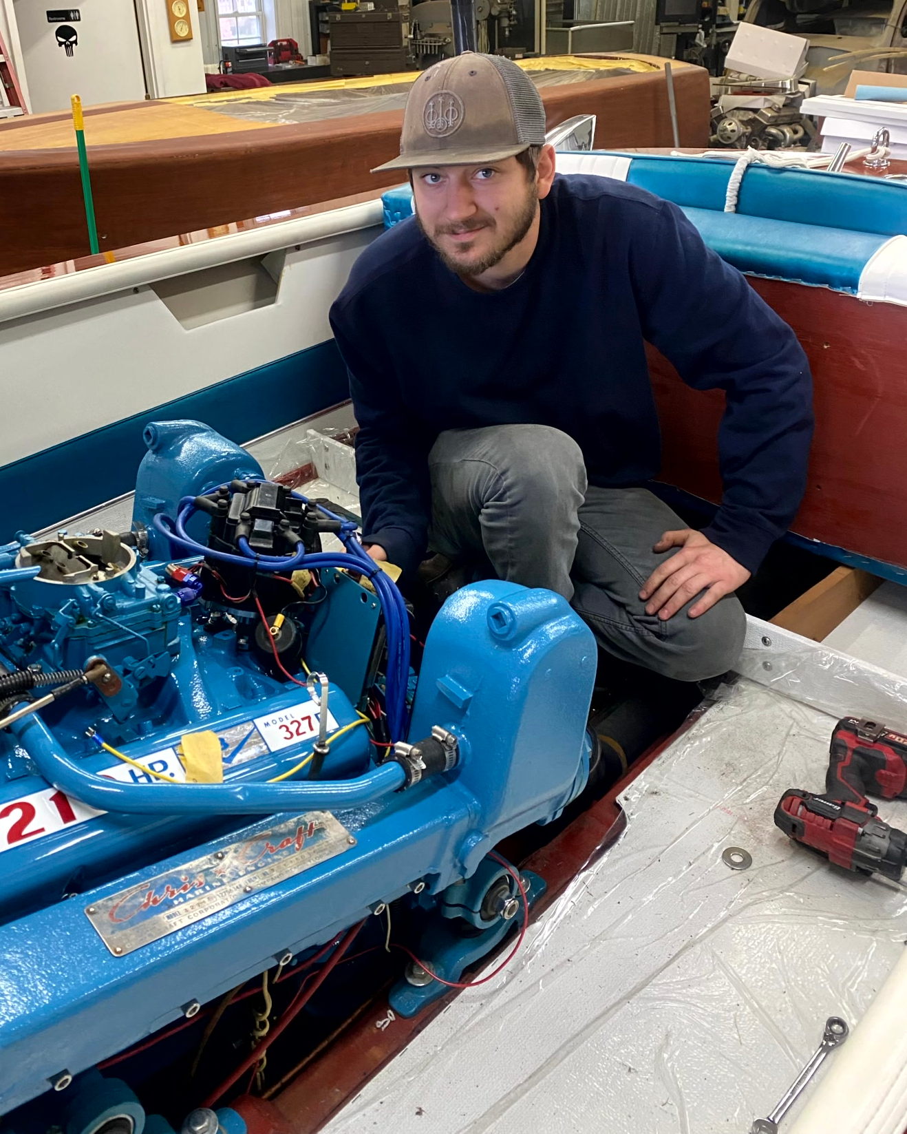 Paul McCoy, co-owner of McCoys Boat Co, working on a classic marine engine