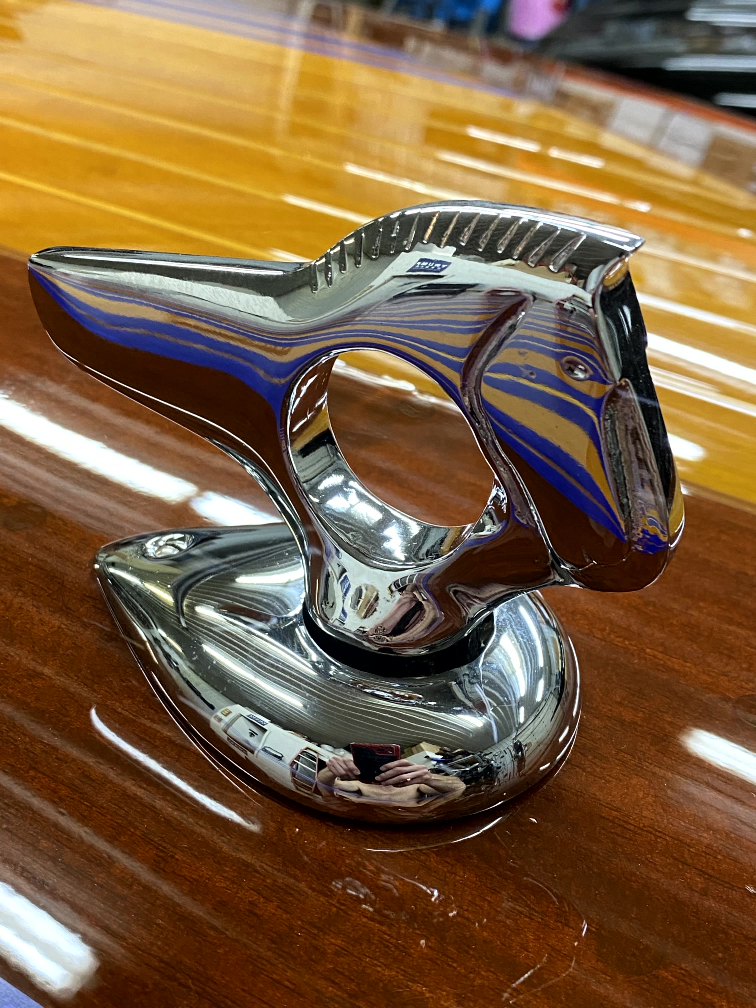Chrome marine hardware on a varnished wooden boat